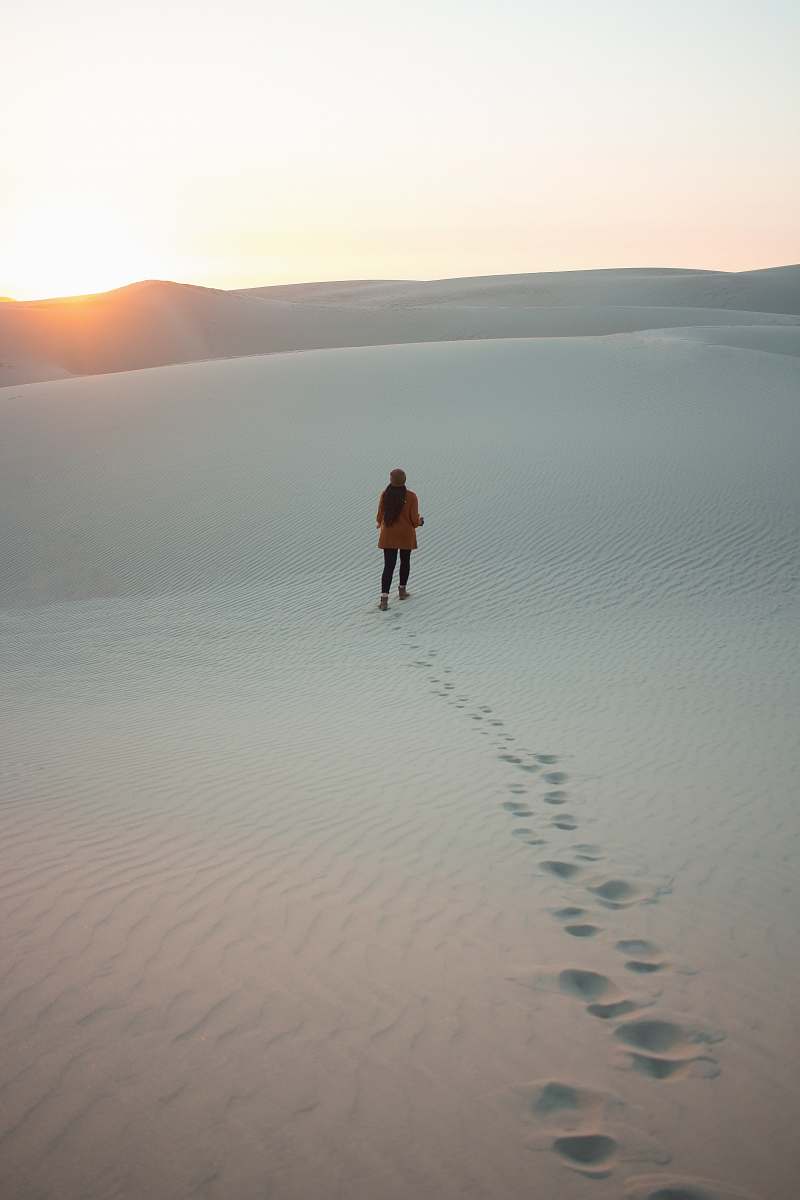 pismo beach woman walking on dessert during daytime sand